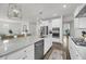 Open kitchen with stainless steel appliances, quartz counters, and wood floors at 3213 Great Egret Dr, Johns Island, SC 29455