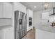 Bright, modern kitchen boasts stainless steel appliances, custom white cabinets, and granite countertops at 3213 Great Egret Dr, Johns Island, SC 29455