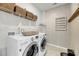 A laundry room featuring a white washer and dryer set with shelving for storage at 3213 Great Egret Dr, Johns Island, SC 29455