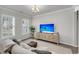 Relaxing living room with natural light, modern furnishings, and a beach-themed media center at 3213 Great Egret Dr, Johns Island, SC 29455