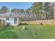 Lush backyard with a wood fence, a stump and space for outdoor activities at 501 E Richardson Ave, Summerville, SC 29485