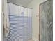 A shower curtain with a blue and white stripe design with a fish emblem in the center at 501 E Richardson Ave, Summerville, SC 29485