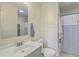 A bathroom with a sink, a toilet, beadboard paneling, and a shower with a blue and white shower curtain at 501 E Richardson Ave, Summerville, SC 29485