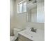 A bathroom with a sink, a toilet, a window, and a shower behind the mirror at 501 E Richardson Ave, Summerville, SC 29485
