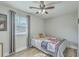 Cozy bedroom with ceiling fan, hardwood floors, and a large window for plenty of natural light at 501 E Richardson Ave, Summerville, SC 29485
