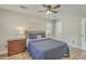 A bedroom with a dark wood dresser, a ceiling fan, and a bed with a dark blue comforter at 501 E Richardson Ave, Summerville, SC 29485