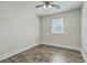 An empty bedroom with hardwood floors, white walls, a ceiling fan, and a window for natural light at 501 E Richardson Ave, Summerville, SC 29485