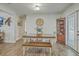 A dining room with a wooden dining table and bench, a corner cabinet, and access to the backyard at 501 E Richardson Ave, Summerville, SC 29485