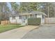 Charming single-story home features solar panels, a well-manicured lawn, and a welcoming front porch at 501 E Richardson Ave, Summerville, SC 29485