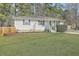 Charming single-story home features solar panels, a well-manicured lawn, and a welcoming front porch at 501 E Richardson Ave, Summerville, SC 29485