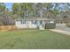 Charming single-story home features solar panels, a well-manicured lawn, and a welcoming front porch at 501 E Richardson Ave, Summerville, SC 29485