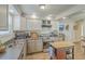 An updated kitchen featuring white cabinets, stainless steel appliances, and a mobile kitchen island at 501 E Richardson Ave, Summerville, SC 29485