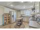 A full kitchen with white cabinets, stainless steel appliances, and a mobile kitchen island at 501 E Richardson Ave, Summerville, SC 29485