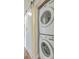Efficient laundry setup features stacked washer and dryer units behind a modern sliding barn door at 501 E Richardson Ave, Summerville, SC 29485