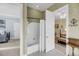 Shared bathroom between bedrooms with a shower-tub, mosaic tile floors, and neutral textured walls at 547 Island Walk, Mount Pleasant, SC 29464
