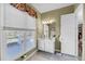 Well-lit bathroom with a bright window view, patterned walls, vanity, and an open door to a connecting room at 547 Island Walk, Mount Pleasant, SC 29464