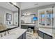 Bright primary bathroom featuring double vanity, soaking tub, and mounted television at 547 Island Walk, Mount Pleasant, SC 29464