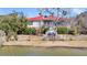 Waterfront home with a red roof, a cozy patio, and serene water views at 547 Island Walk, Mount Pleasant, SC 29464