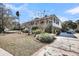 Home featuring an expansive front porch and driveway with detailed brick border at 547 Island Walk, Mount Pleasant, SC 29464