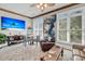 Bright living room boasts large windows, beach-themed television, and decorative ceiling fan at 547 Island Walk, Mount Pleasant, SC 29464