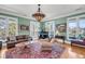 Elegant living room featuring hardwood floors, large windows, and a comfortable seating arrangement at 547 Island Walk, Mount Pleasant, SC 29464