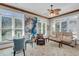 Inviting living room with ceiling fan, neutral tones, and ample natural light from large windows at 547 Island Walk, Mount Pleasant, SC 29464