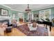 Inviting living room with fireplace, hardwood floors, a comfortable seating area, and grand piano at 547 Island Walk, Mount Pleasant, SC 29464