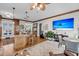 Open living area includes a kitchen island with seating, hardwood floors, and a TV for entertaining at 547 Island Walk, Mount Pleasant, SC 29464