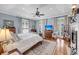Airy main bedroom boasting hardwood floors, a fireplace, a white ceiling fan, and natural light at 547 Island Walk, Mount Pleasant, SC 29464
