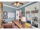 Bright home office with built-in shelving, large desk, and French doors to porch at 547 Island Walk, Mount Pleasant, SC 29464