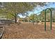 Community playground surrounded by trees and mulch at 547 Island Walk, Mount Pleasant, SC 29464