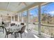 A screened-in porch with dining area overlooking scenic waterfront views at 547 Island Walk, Mount Pleasant, SC 29464