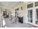 Inviting covered porch with seating, decorative lamps, and views at 547 Island Walk, Mount Pleasant, SC 29464