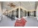 Expansive covered porch with rocking chairs and a swing, perfect for enjoying the outdoors at 547 Island Walk, Mount Pleasant, SC 29464