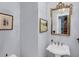 Powder room with pedestal sink, updated fixtures, and artwork on the wall at 547 Island Walk, Mount Pleasant, SC 29464