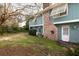 Backyard featuring a brick chimney, back door, and lush lawn at 6 4Th Ave, Isle of Palms, SC 29451