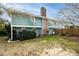 Spacious backyard with green grass, a brick chimney, and partially fenced area, perfect for outdoor activities at 6 4Th Ave, Isle of Palms, SC 29451
