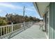 Tranquil balcony with teal flooring, white railings, and neighborhood views offering a relaxing outdoor space at 6 4Th Ave, Isle of Palms, SC 29451