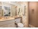 Quaint bathroom with a peach-toned shower, vanity, and playful wallpaper, offering a unique and cozy feel at 6 4Th Ave, Isle of Palms, SC 29451
