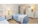 Cozy bedroom featuring two twin beds with matching decor, bedside tables, and plenty of natural light at 6 4Th Ave, Isle of Palms, SC 29451