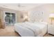 Cozy bedroom with ceiling fan, sliding glass doors to deck and rocking chair at 6 4Th Ave, Isle of Palms, SC 29451