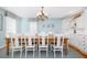 Formal dining room with large wooden table and chairs, chandelier, and built in cabinets at 6 4Th Ave, Isle of Palms, SC 29451