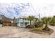 Two story home featuring a light blue exterior, white trim, front yard, and multi-car driveway at 6 4Th Ave, Isle of Palms, SC 29451