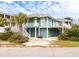 Quaint beach home with a wraparound porch, lush landscaping, and a coastal charm at 6 4Th Ave, Isle of Palms, SC 29451