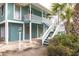 Coastal home featuring stairs to the entrance, palm trees, and a charming exterior paint color at 6 4Th Ave, Isle of Palms, SC 29451