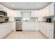 Well-lit kitchen with white cabinets, stainless steel appliances, and plenty of counter space for meal preparation at 6 4Th Ave, Isle of Palms, SC 29451