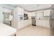 Bright kitchen featuring white cabinetry, stainless steel appliances, and an open layout connected to the dining area at 6 4Th Ave, Isle of Palms, SC 29451