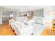 Bright living room with hardwood floors, comfortable seating, and an open view to the kitchen and dining area at 6 4Th Ave, Isle of Palms, SC 29451