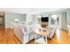 Light-filled living room boasting hardwood floors, cozy furniture, and sliding doors to an outdoor balcony at 6 4Th Ave, Isle of Palms, SC 29451