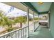 Inviting porch with outdoor furniture and a scenic view of the street and palm trees at 6 4Th Ave, Isle of Palms, SC 29451